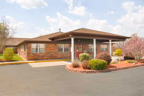 Life Care Center of LaGrange front entrance with shrubs and brick facade.