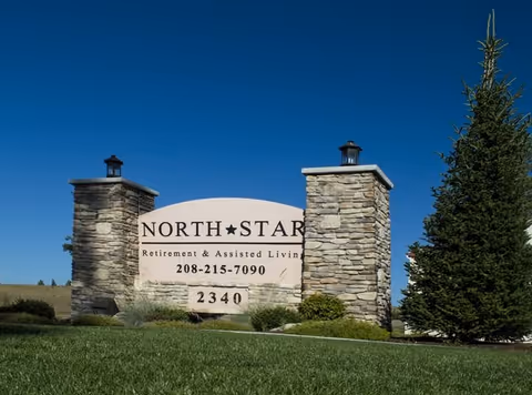 Stone entrance sign for North Star Retirement & Assisted Living on a grassy lawn displaying the phone number and address 2340.