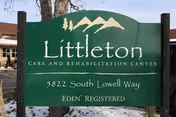 Green sign for Littleton Care and Rehabilitation Center with white text displaying the address 5822 South Lowell Way and the phrase EDEN REGISTERED, set outdoors with a building and tree visible in the background.