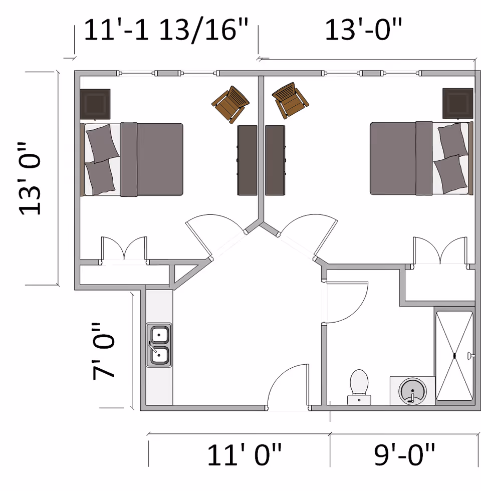 Architectural floor plan of a living space at The Phoenix at Tucker showing two bedrooms, a shared living area with a kitchen sink, and a bathroom with a toilet, sink, and shower. Dimensions of rooms are marked around the plan.