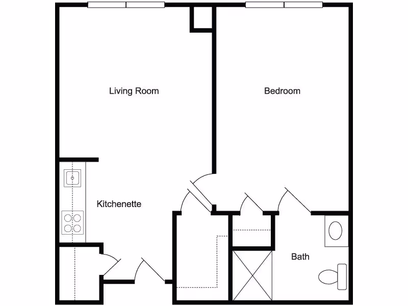 Floor plan of a senior living unit at Charter Senior Living of Woodbridge showing a living room, kitchenette, bedroom, and bathroom with labeled areas and fixtures.