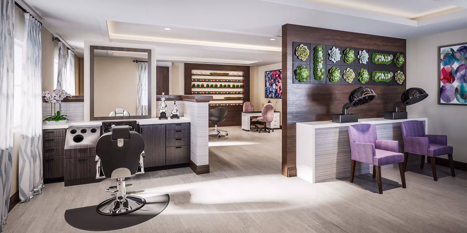 A modern salon area inside a senior living facility featuring a black salon chair in front of a large mirror and countertop with drawers. To the right, there are two purple chairs under hair drying stations mounted on a white counter with a dark wood accent wall decorated with framed succulent artwork. In the background, there is a workspace with desks and chairs, and colorful artwork on the walls. The room is well-lit with natural light coming through windows with sheer curtains.
