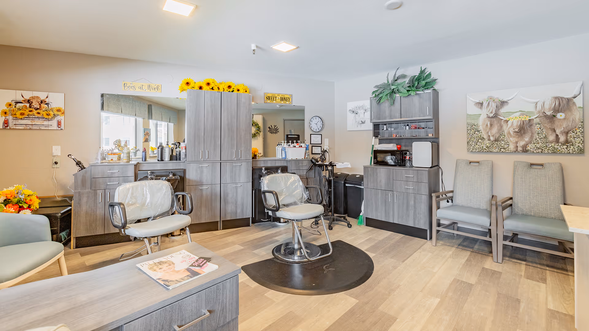 Well-lit interior salon area with styling chairs, cabinets, and waiting chairs decorated with sunflower accents.