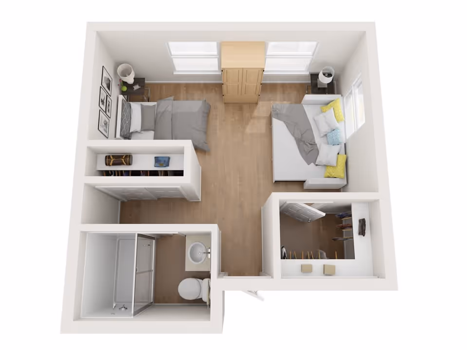 Top-down view of a small apartment floor plan showing a bedroom with a bed, nightstand, and wardrobe, a living area with a sofa and cushions, a walk-in closet, and a bathroom with a shower, toilet, and sink.