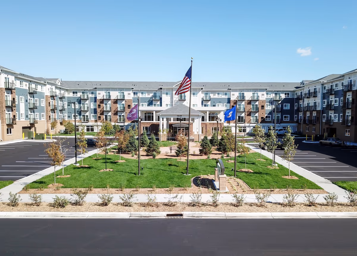 Exterior view of Affinity at Ramsey with a central courtyard, flags, and surrounding residential buildings.