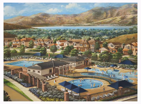 A scenic view of a senior living community featuring multiple residential buildings surrounded by trees and greenery. In the foreground, there are two swimming pools with lounge chairs and shaded seating areas. The background shows a large body of water and rolling hills under a partly cloudy sky.