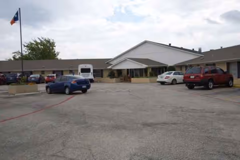 Front exterior of Country View Nursing & Rehabilitation with a parking lot and cars