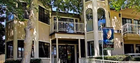 Exterior of Brookdale North Euclid, a cream-colored senior living building with balconies and banners.