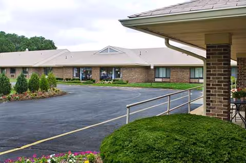 Exterior view of Crestview Center showing brick building, parking lot, and landscaped shrubs.