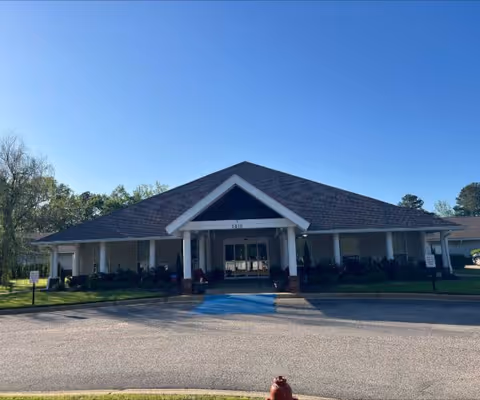 North River Village senior living facility entrance with covered front porch and accessible ramp.