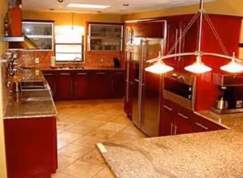 Kitchen in a senior living facility featuring stainless appliances and granite countertops.