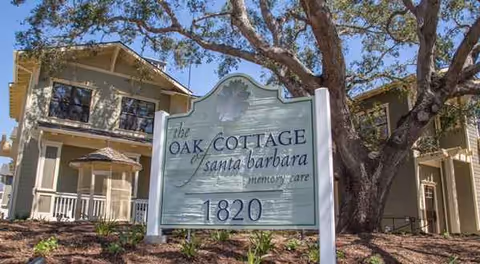 Front sign for The Oak Cottage of Santa Barbara memory care in front of a building.