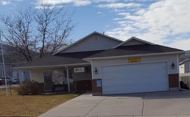 Exterior of BeeHive Homes Assisted Living: a single-story building with a two-car garage.