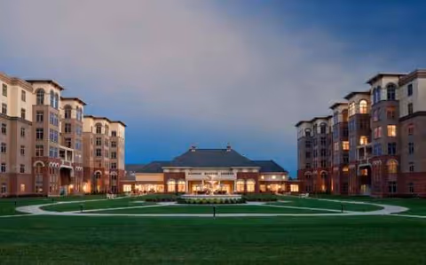 Exterior view of Providence Point campus with central courtyard and lit entrances at dusk.