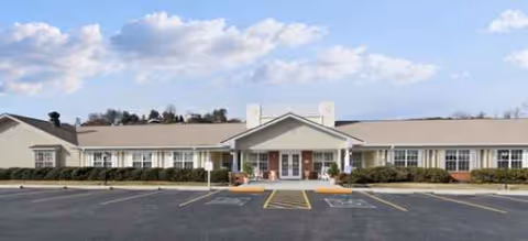 Front view of TerraBella Morristown senior living facility with parking lot and entrance.