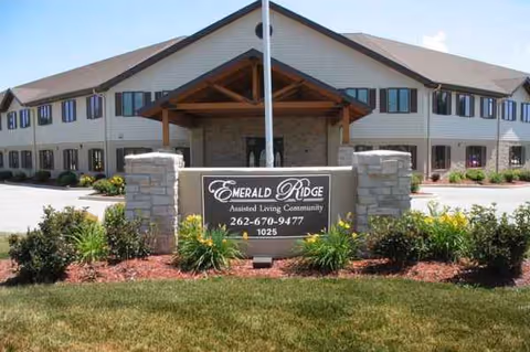 Exterior view of Emerald Ridge Assisted Living Community with front sign and landscaping