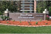 A RiverPointe Senior Living sign with landscaping and a building behind.