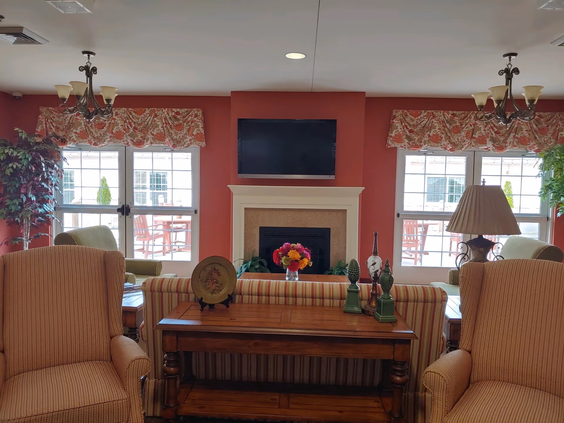 Cozy living room with sofas, a coffee table, fireplace, and a wall-mounted TV.