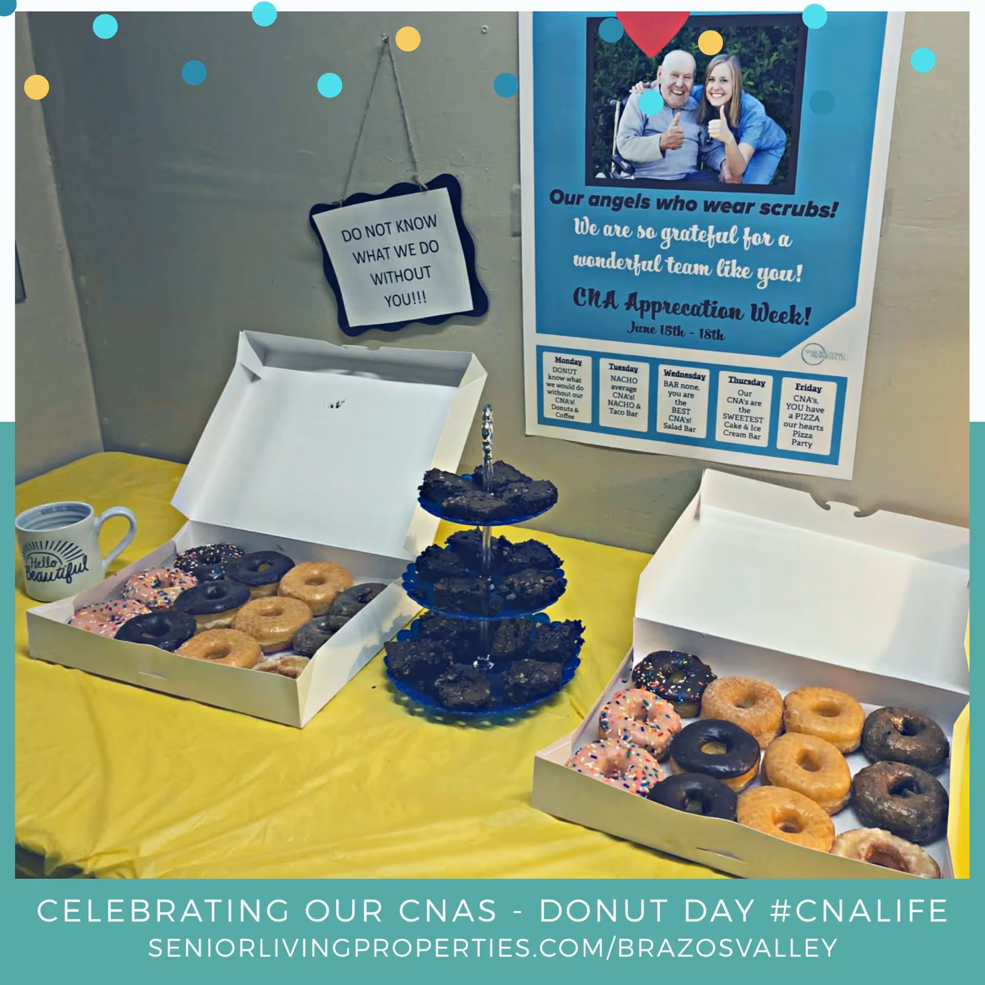 A table covered with a yellow tablecloth displaying two open boxes of assorted donuts and a three-tiered stand with brownies. A coffee mug with the words 'Hello Beautiful' is also on the table. On the wall behind, there is a sign that says 'DO NOT KNOW WHAT WE DO WITHOUT YOU!!!' and a poster appreciating CNAs with a photo of a smiling elderly man and a woman giving thumbs up.