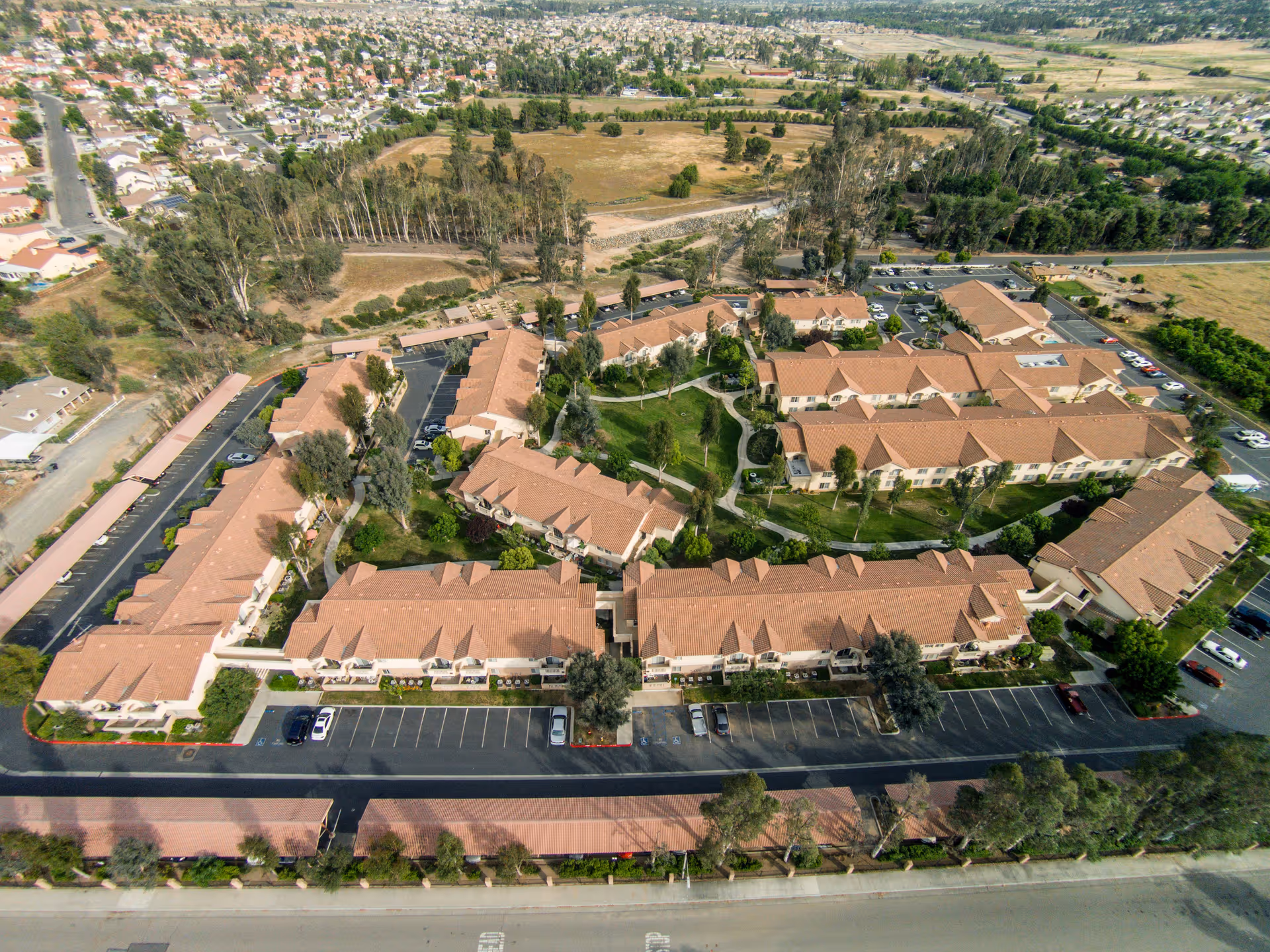 Aerial view of the Wildomar Senior Assisted Living complex showing multiple connected buildings, parking areas and landscaped courtyards.
