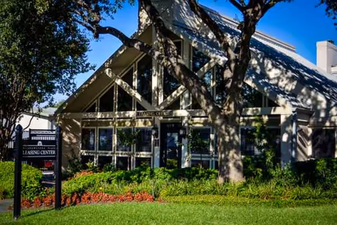 Meadowstone Place senior living facility front facade with trees and landscaping