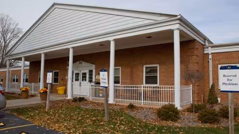 Exterior view of Meadowbrook at Appleton entrance with brick walls and white columned portico.