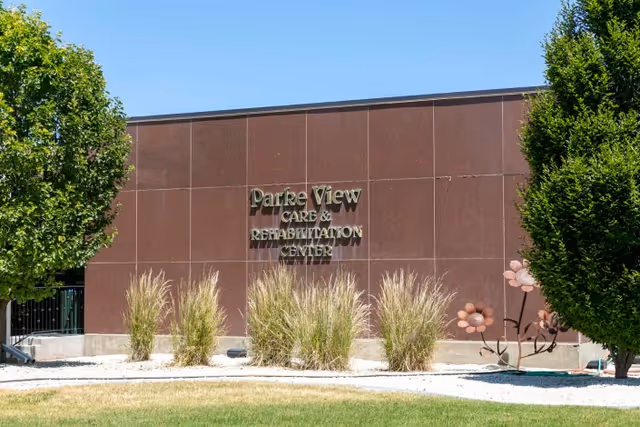 Front exterior wall of Parke View Care & Rehabilitation Center with its sign and landscaping.