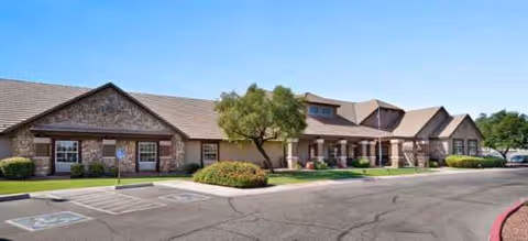 Exterior view of Brookdale Peoria facility with parking lot and entrance.