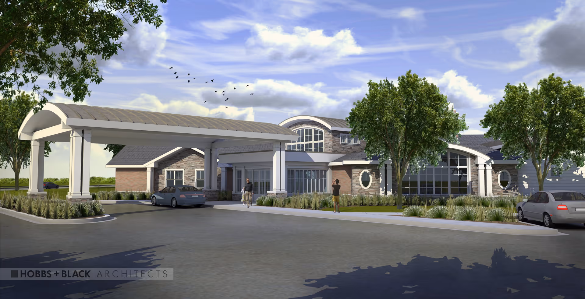 Exterior view of a modern senior living facility with a covered entrance, two cars parked nearby, trees, and two people walking near the entrance under a partly cloudy sky.