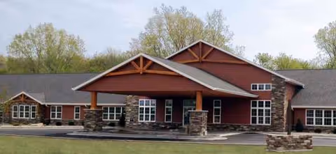 Exterior view of Autumn's Promise Assisted Living with brick facade and covered entry.