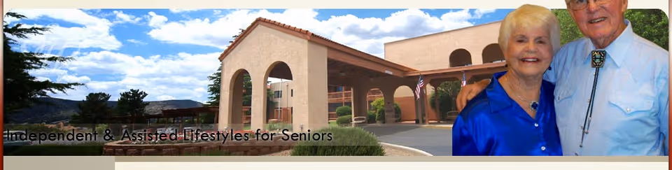 Entrance of a retirement home building with arches and a covered driveway under a partly cloudy sky, with two smiling elderly individuals standing on the right side of the image.