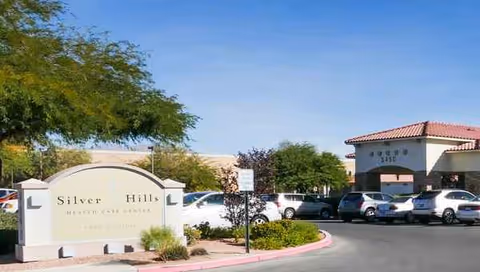 Front view of Silver Hills Health Care Center with a curved sign and parking lot.