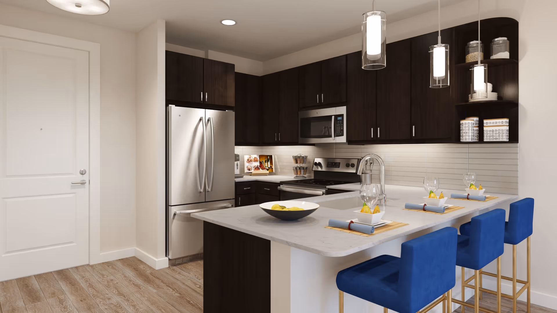 Modern kitchen with a marble island, four blue barstools, dark cabinets, and stainless steel appliances.