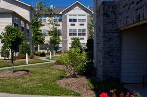 Exterior view of Westchester Manor Nursing Center with landscaped lawns and trees.