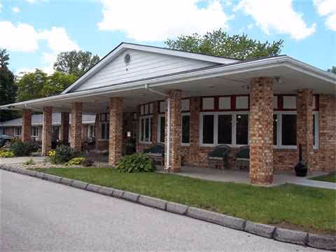 Front view of Norwalk Nursing & Rehab Center with brick exterior and covered entrance.