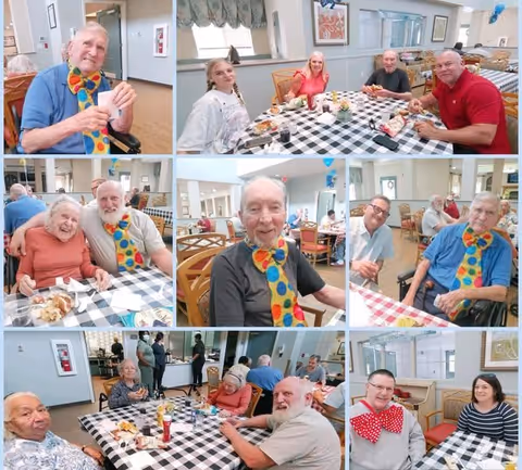 A collage of photos showing elderly residents at Proveer at Northgate enjoying a meal together in a dining room. The residents are seated at tables covered with checkered tablecloths, smiling and interacting with each other. Some are wearing colorful oversized bow ties. The setting is bright and welcoming with light-colored walls and large windows.