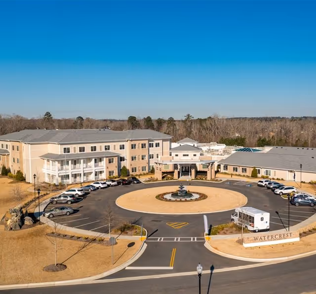 Aerial view of the Watercrest Macon senior living building with a circular driveway and central fountain.