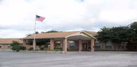 Bluebonnet Nursing and Rehabilitation building exterior with flagpole and parking.