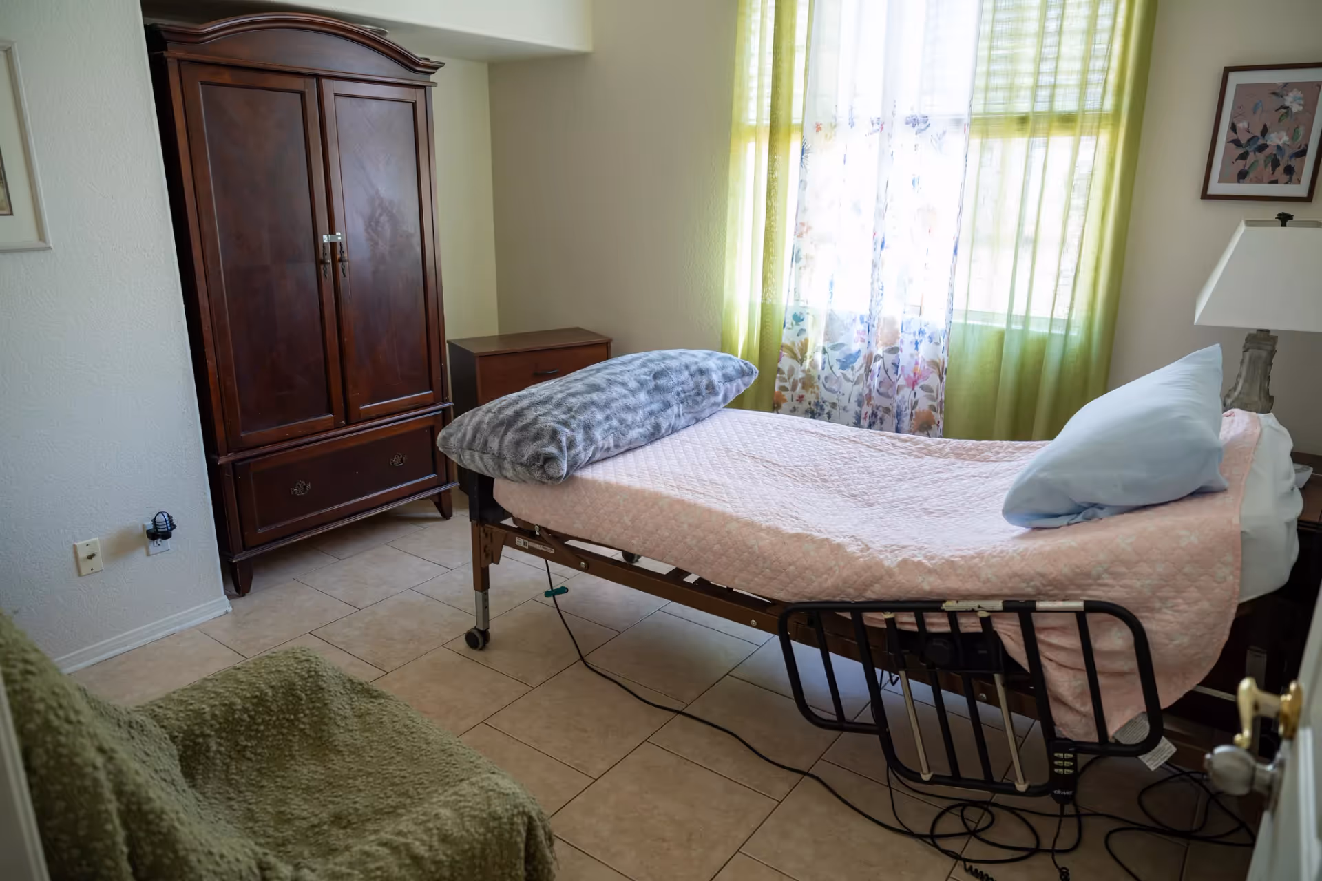 Adjustable hospital bed in a cozy senior living bedroom.