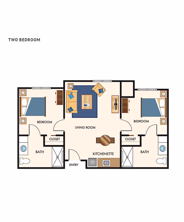 Floor plan of a two-bedroom apartment featuring two bedrooms each with a closet and a bathroom, a central living room with seating and a coffee table, and a kitchenette near the entry.
