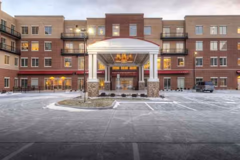Exterior view of Creve Coeur Assisted Living and Memory Care entrance with snow.