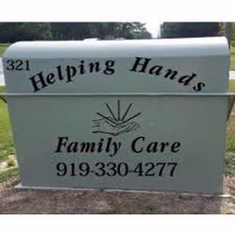 Outdoor sign for Helping Hands Family Care with contact details.
