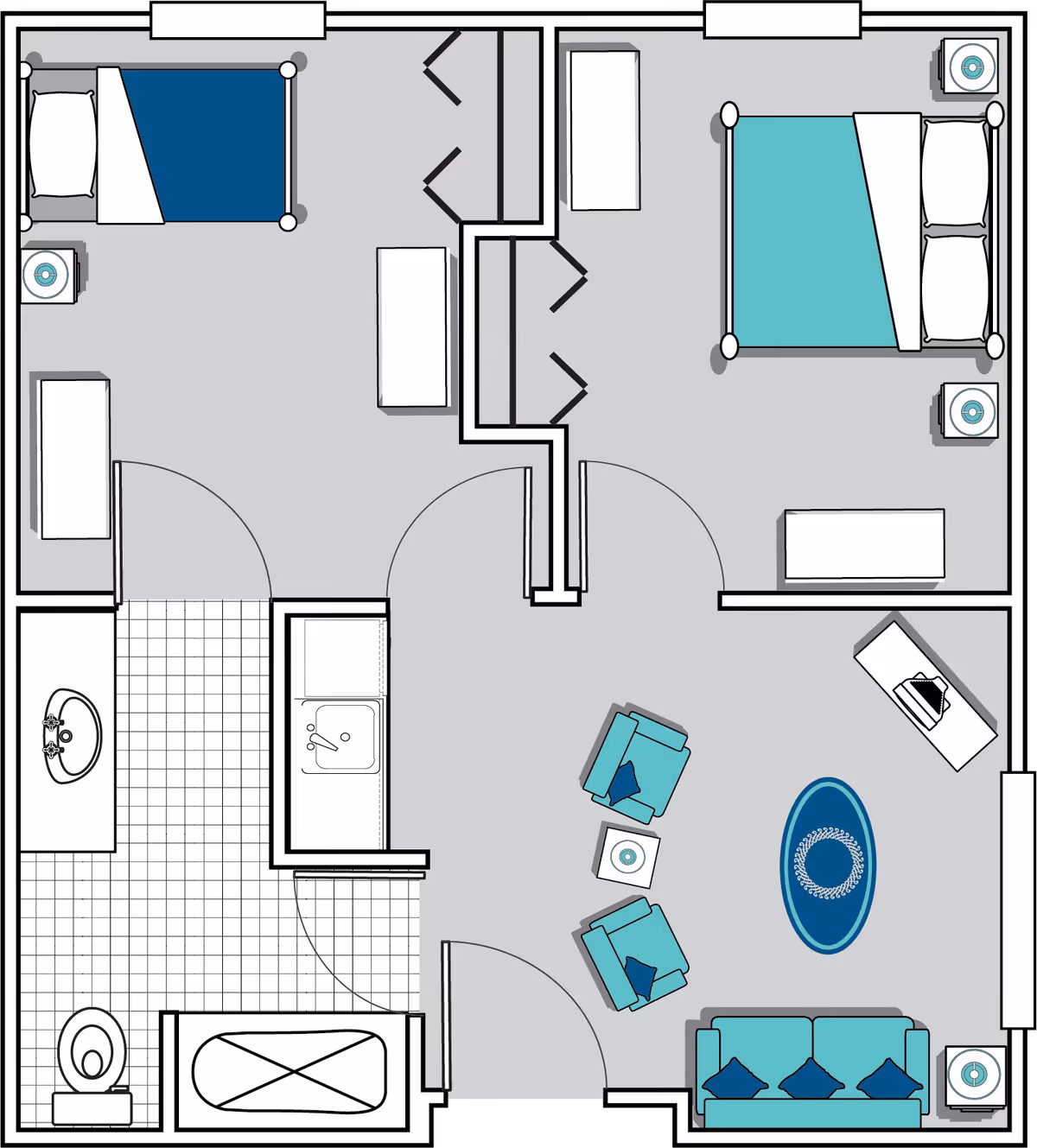 Floor plan of a residential unit at Oaks at Cedar Shoals showing two bedrooms, a bathroom with a bathtub, toilet, and sink, and a living room area with a sofa, two armchairs, a coffee table, and a TV stand.