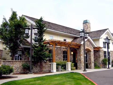 Exterior view of Marquis Wilsonville Assisted Living facility with stone facade and entryway.