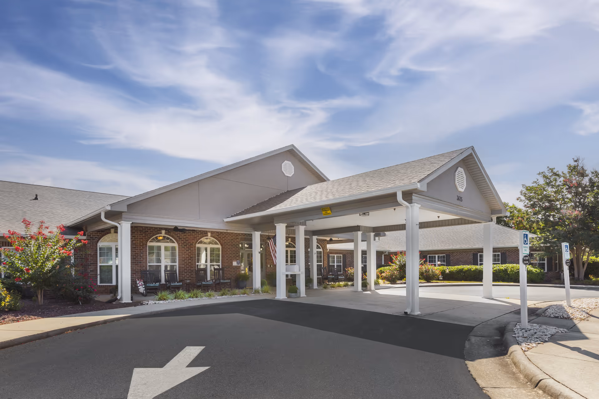 Exterior view of Brookdale Burlington with a covered entrance and circular driveway.