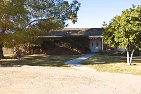 Elder's Ranch is a single-story facility exterior with a front walkway and trees.