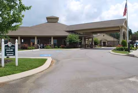 Front view of Morning Pointe entrance with driveway and flagpole.