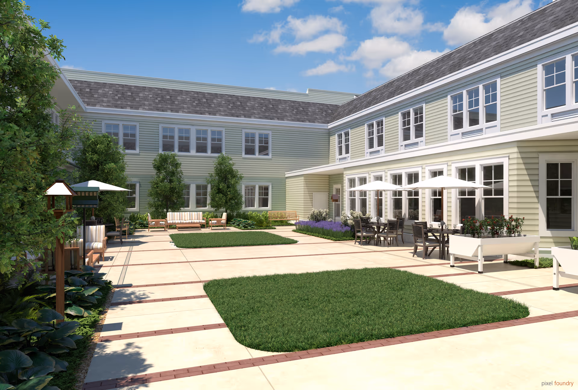 Outdoor courtyard area of a senior living facility with green grass patches, paved walkways, patio tables with umbrellas, chairs, benches, and surrounding two-story building with many windows under a partly cloudy blue sky.