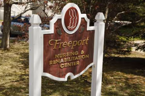 Outdoor sign reading Freeport Nursing & Rehabilitation Center on a grassy area.