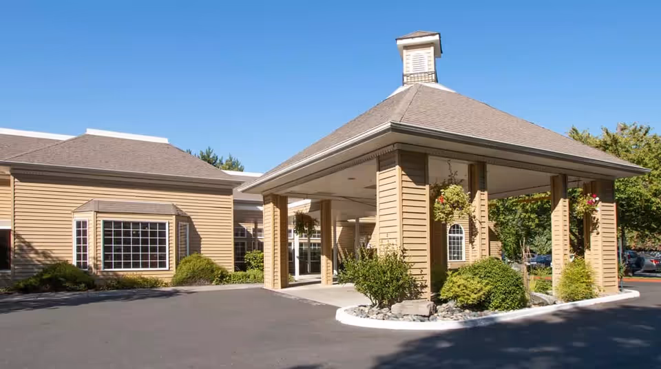 Exterior view of Avamere Rehabilitation of Cascade Park entrance with a covered canopy and columns.